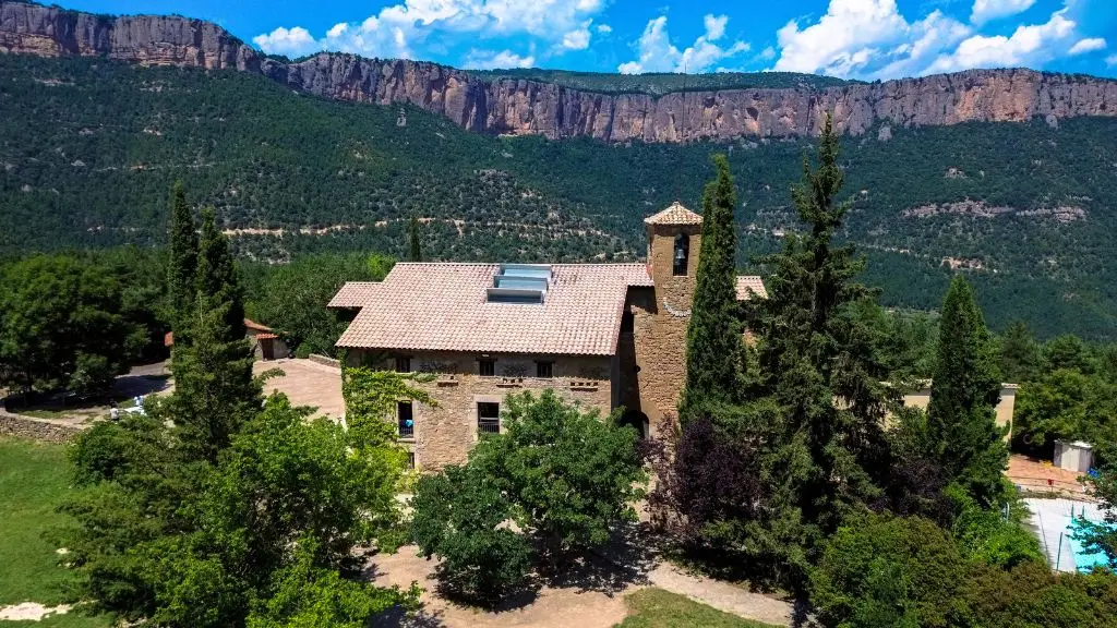 Foto des de l'aire de la casa de colònies La Rectoria de la Selva i els seus voltants amb les cingleres